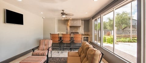 a living room with a table and chairs and a large window